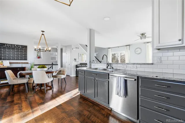 a kitchen with stainless steel appliances granite countertop a stove and cabinets