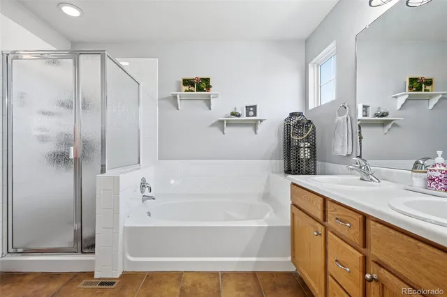 a bathroom with a tub sink and mirror