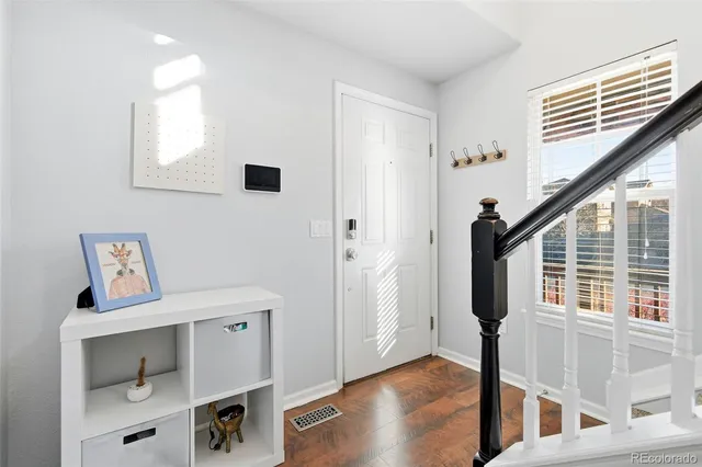 a view of entryway with workspace and wooden floor