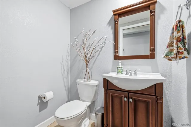 a bathroom with a toilet a sink and a mirror