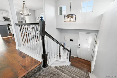 a view of entryway and hall with wooden floor