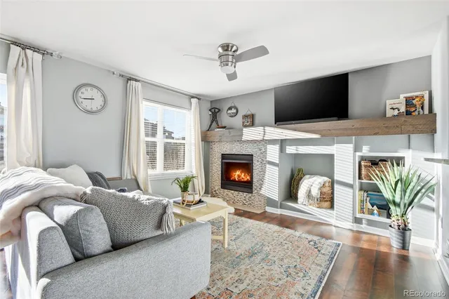 a living room with furniture fireplace and flat screen tv