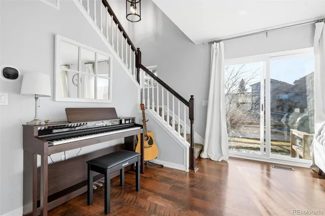 a kitchen with wooden floor and a window