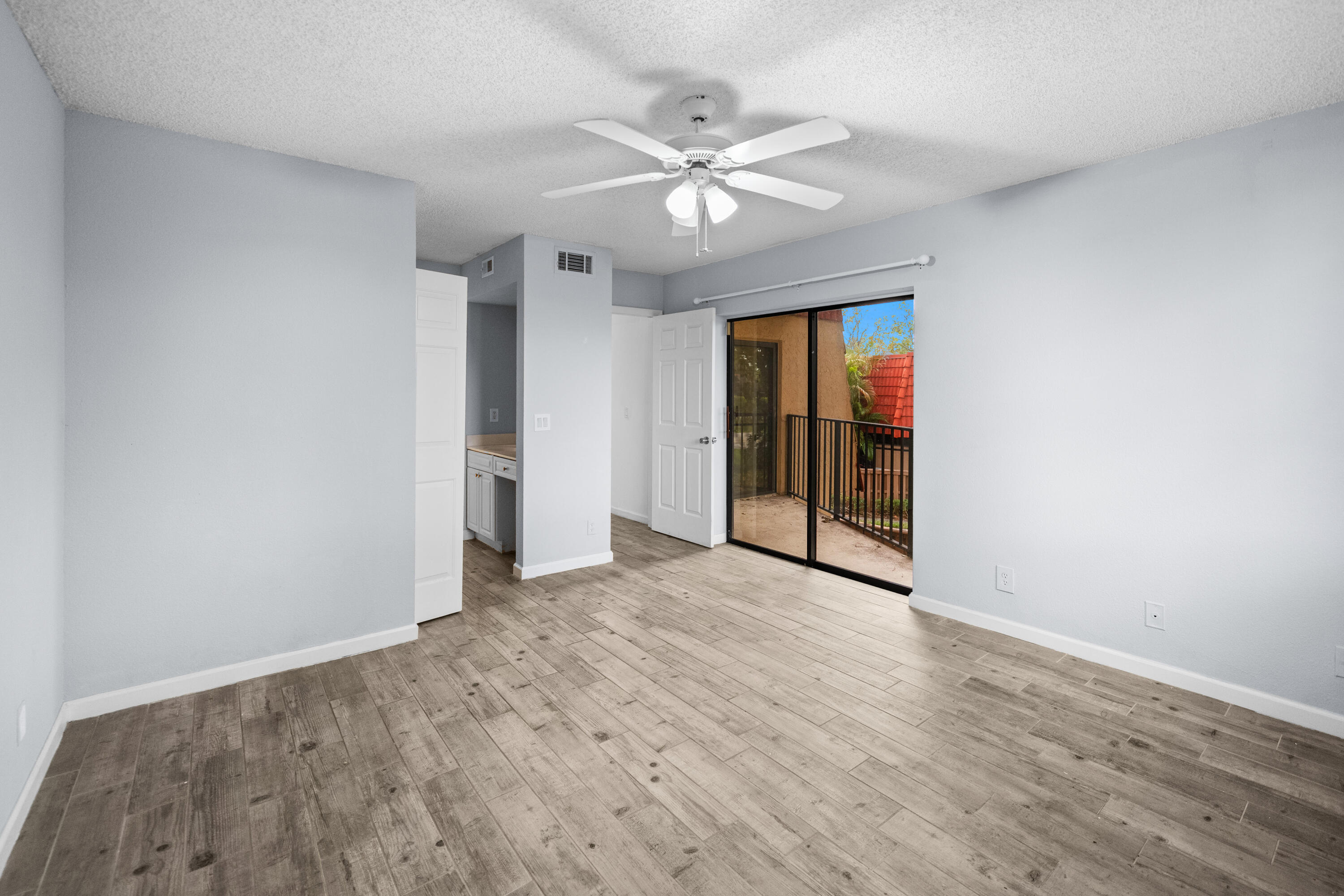 8237 Severn Drive, Unit A Boca Raton, FL 33433 - Photo 17 of 19 wooden floor in an empty room with a window