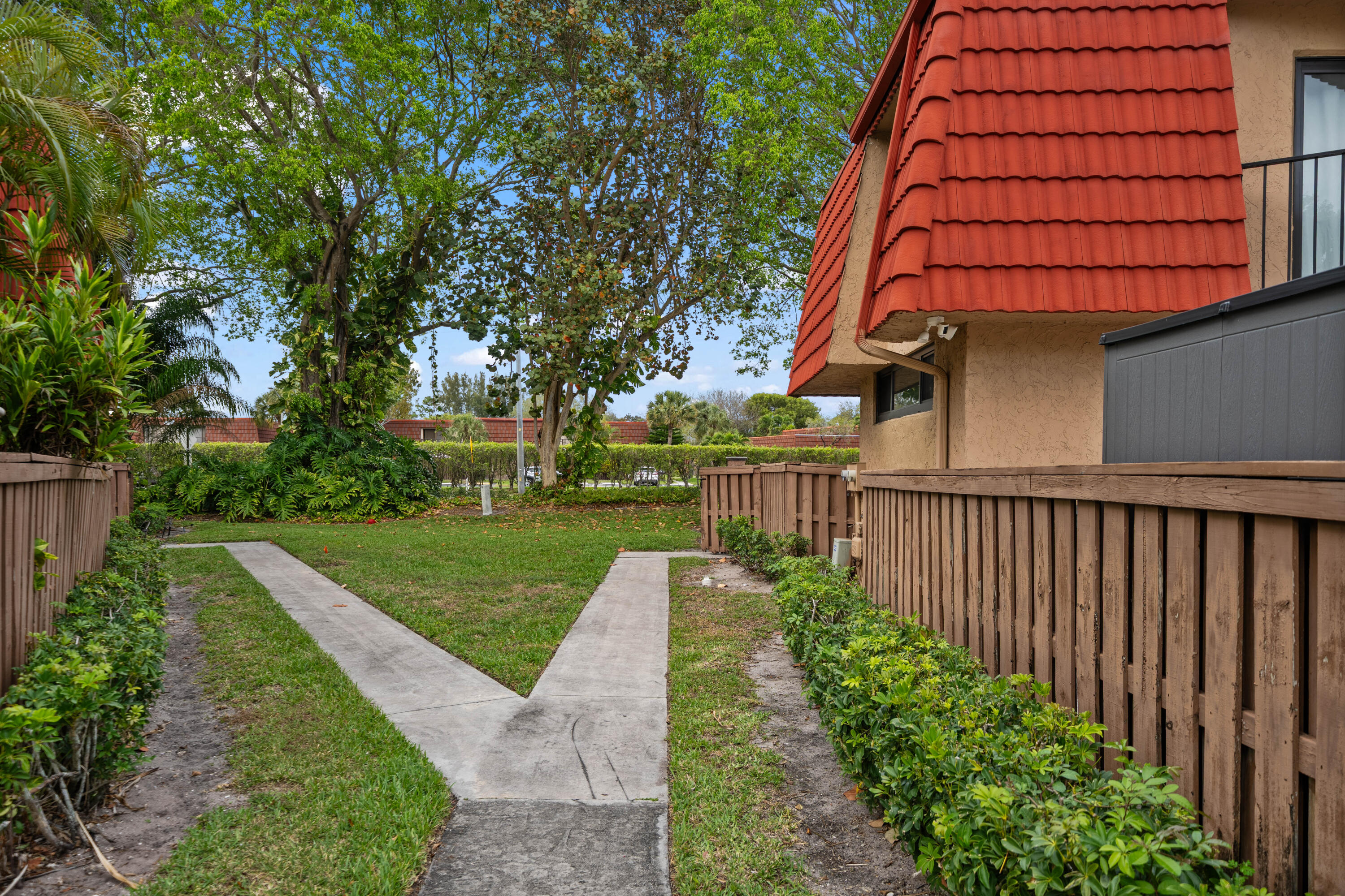 8237 Severn Drive, Unit A Boca Raton, FL 33433 - Photo 2 of 19 a front view of a house with a yard
