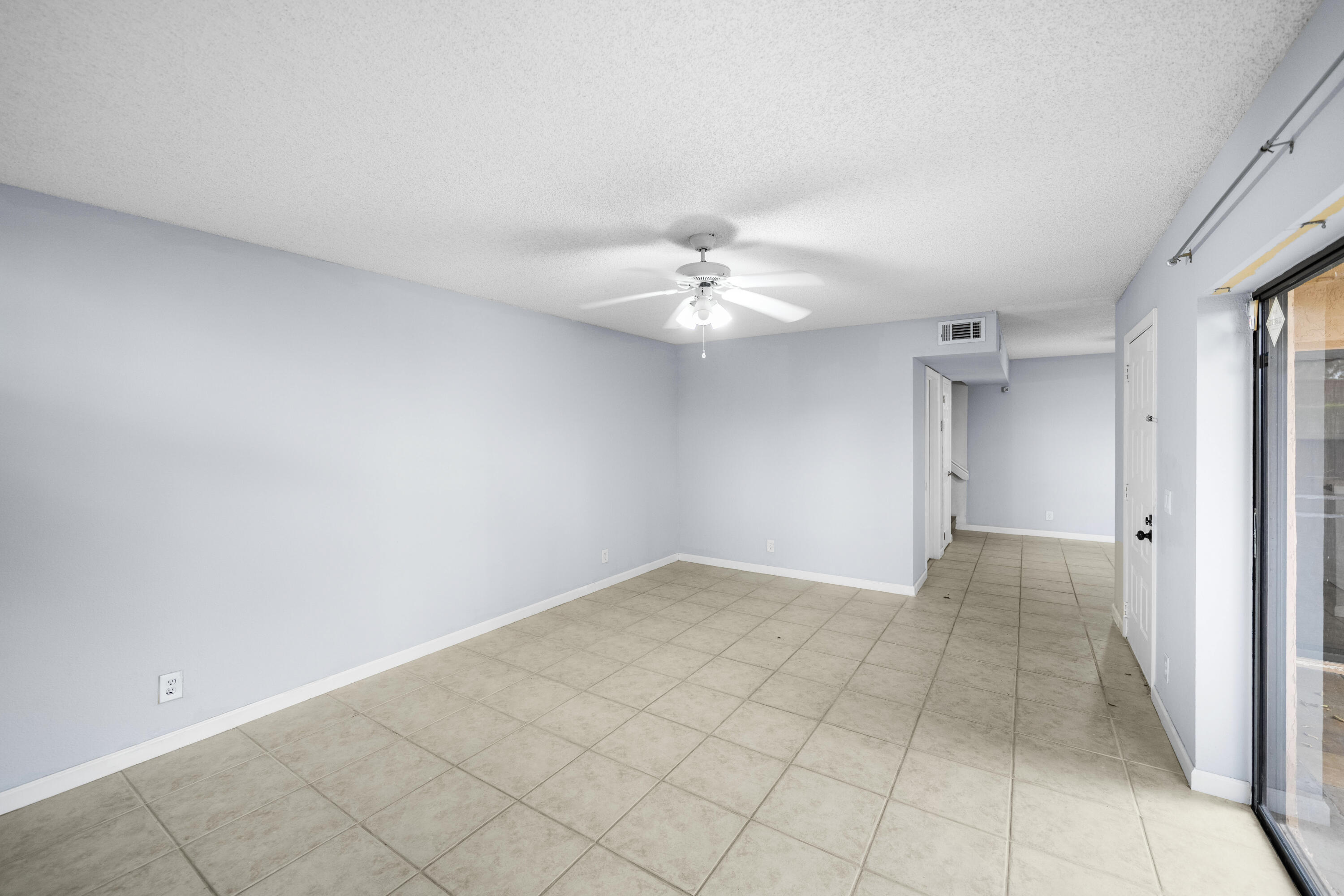 8237 Severn Drive, Unit A Boca Raton, FL 33433 - Photo 5 of 19 a view of an empty room with a chandelier fan