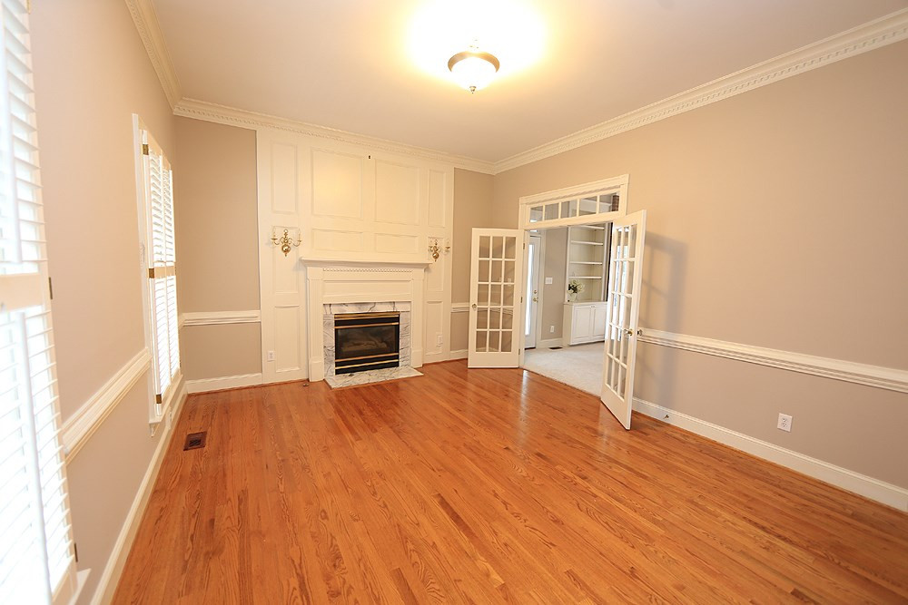8617 Cold Springs Road Raleigh, NC 27615 - Photo 4 of 30 Use this room how it best fits your family. Would also make a great music room. This has one of three fireplaces. Living Room/Office