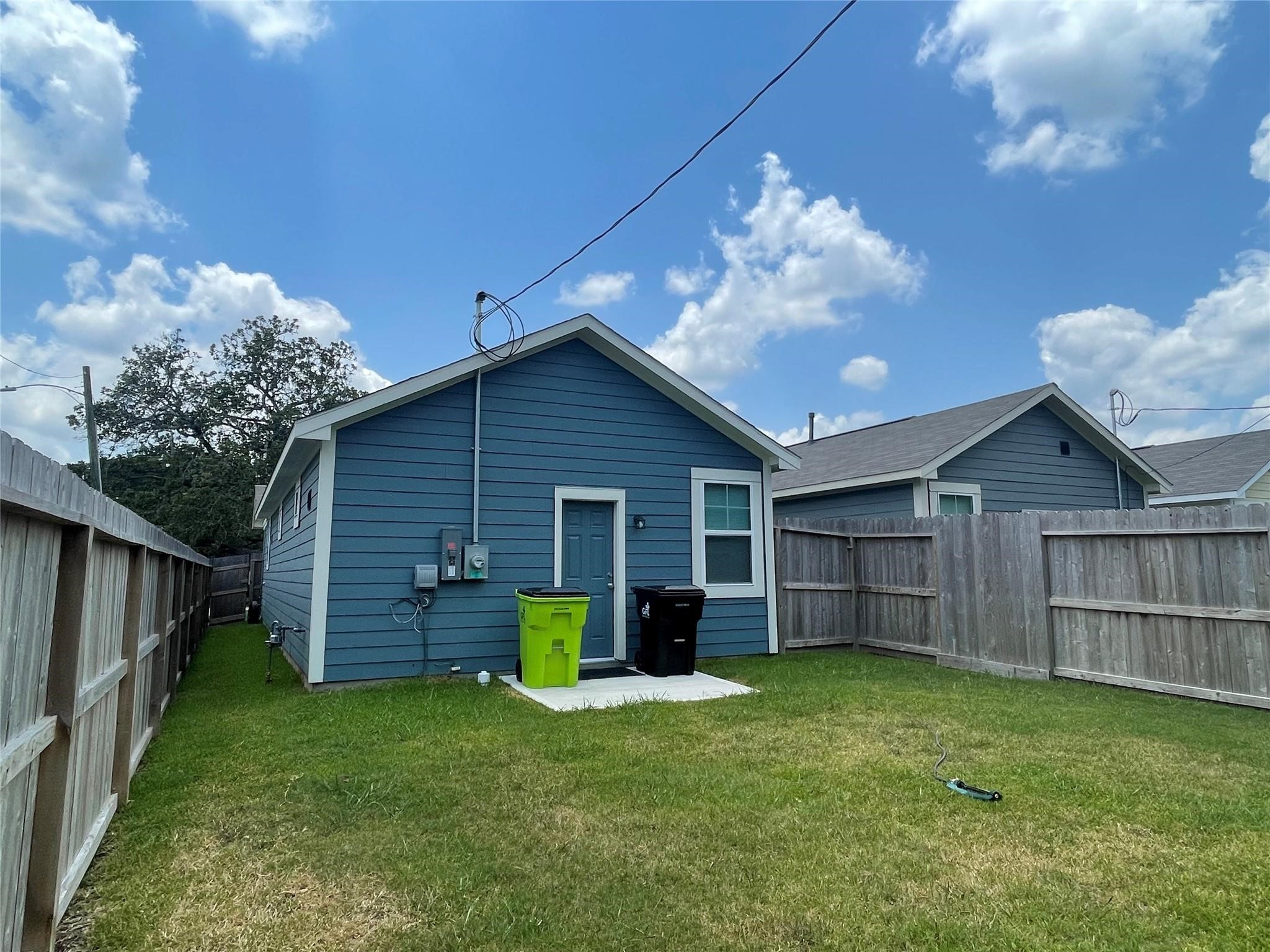 1137 4th Street Rosenberg, TX 77471 - Photo 16 of 16 a view of a house with backyard and wooden fence