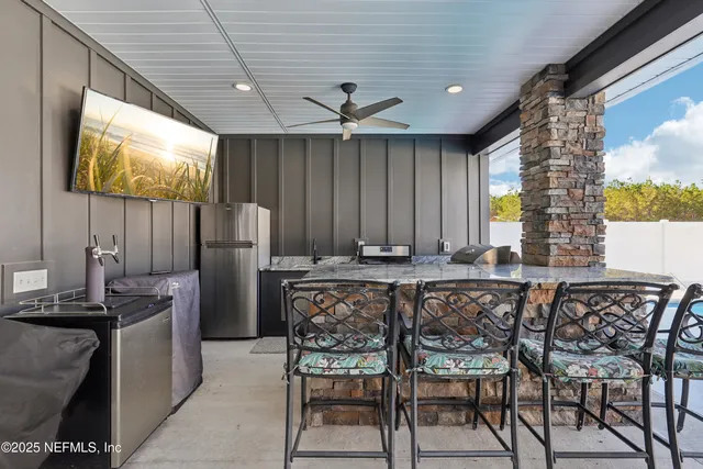 a view of a dry yard with wooden fence