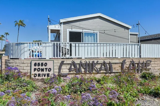 a view of a house with swimming pool and sitting area