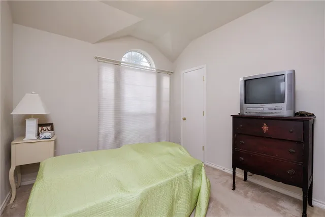 a bedroom with a bed and a television