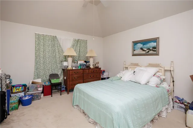 a bedroom with a bed a desk and chair