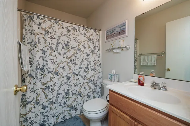 a bathroom with a sink toilet and a mirror