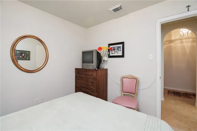 a bedroom with a bed and a mirror