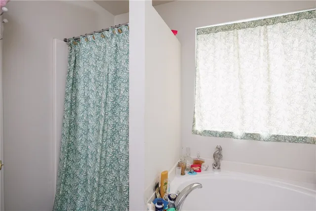 a bathroom with a bathtub and shower