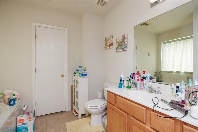 a bathroom with a sink vanity mirror and toilet