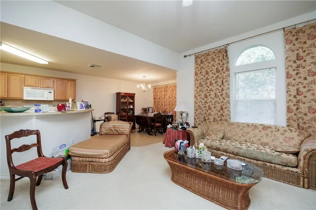 a living room with furniture kitchen and a window