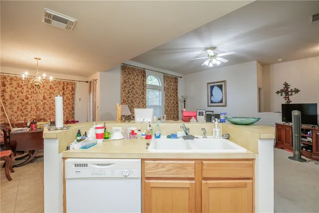 a kitchen with kitchen island white cabinets and chandelier