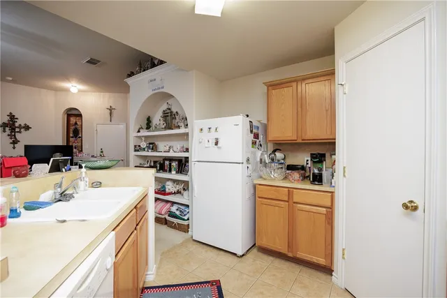 a kitchen with a white cabinets and white appliances
