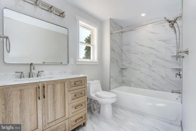 a bathroom with a sink a toilet and bathtub