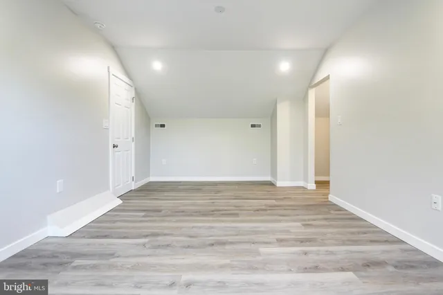 a view of a room with wooden floor