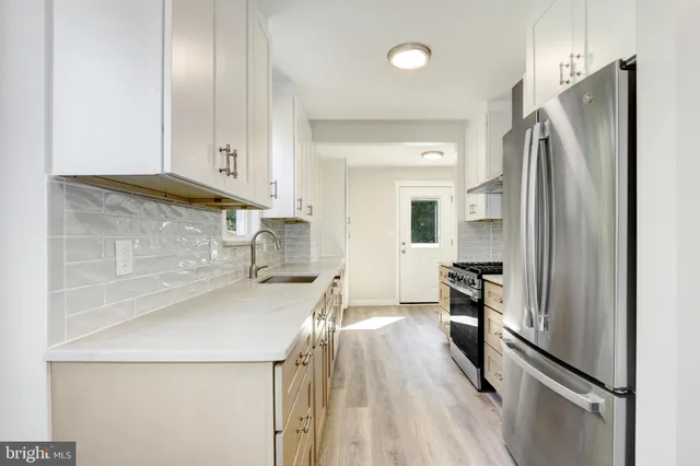a kitchen with stainless steel appliances a refrigerator and a stove