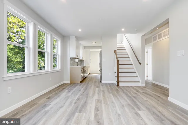 a view of a room with wooden floor and stairs
