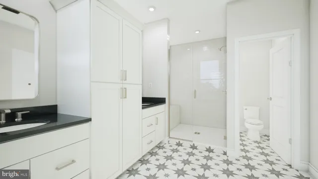 a bathroom with a shower and a sink