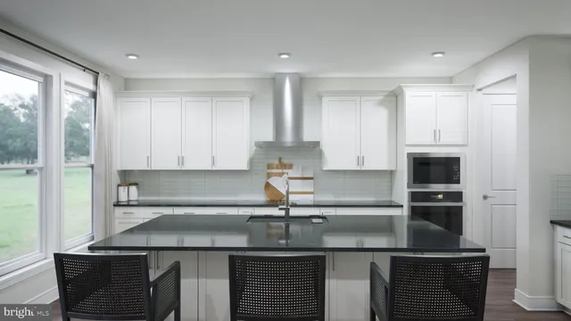 a kitchen with kitchen island a sink appliances and cabinets