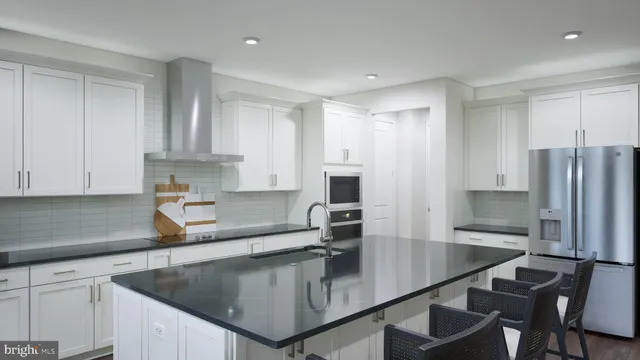 a kitchen with kitchen island a counter top space cabinets and stainless steel appliances