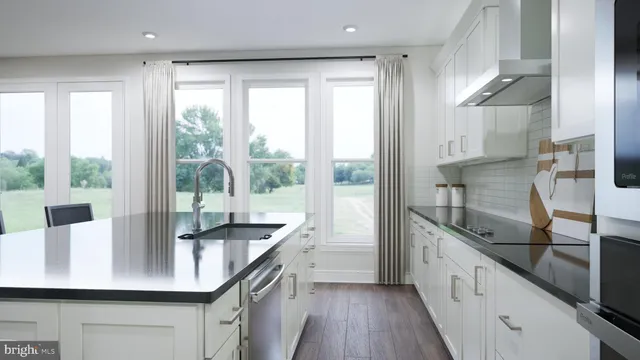 a kitchen with counter top a sink cabinets and appliances
