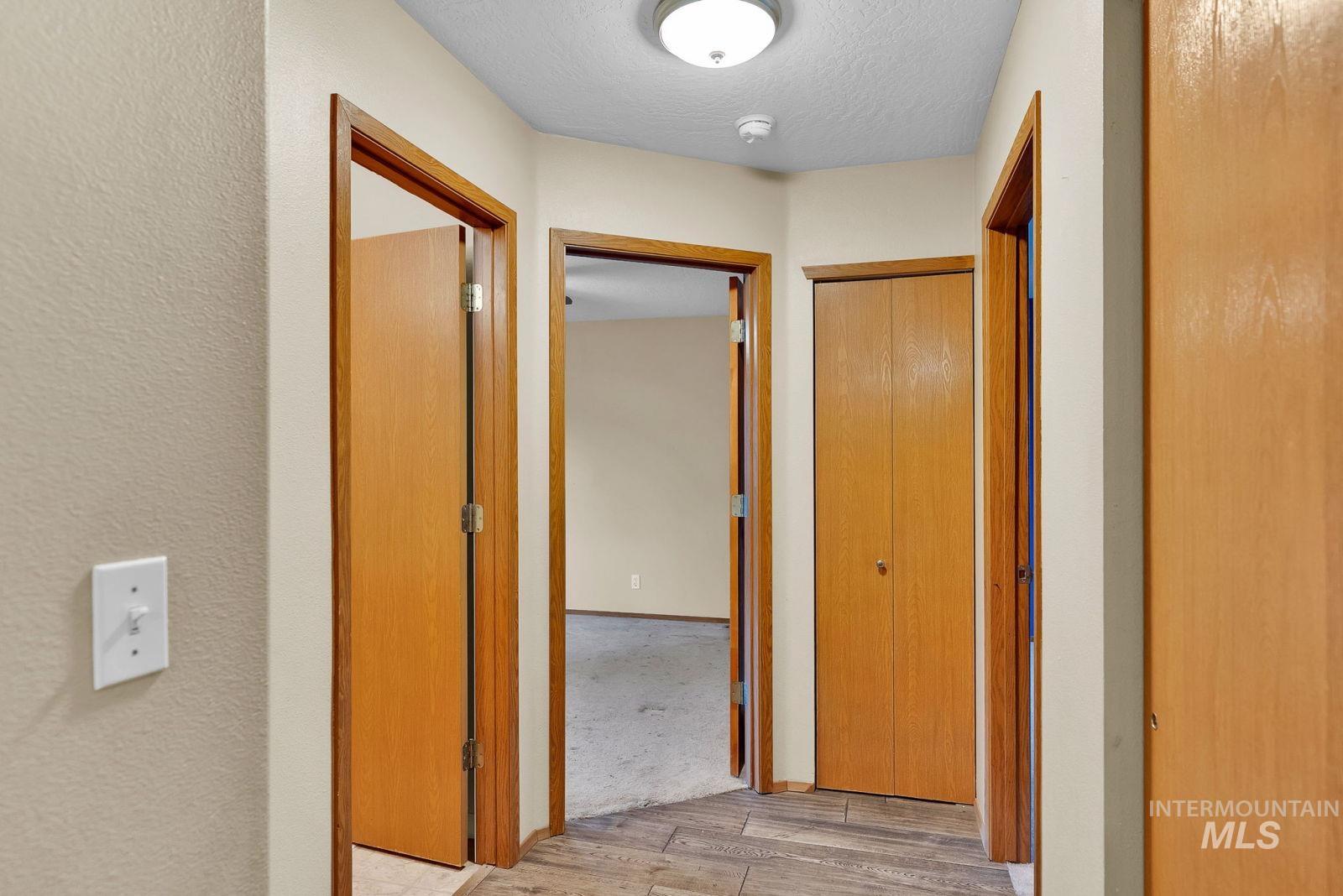 8561 Nebraska Street Rathdrum, ID 83858 - Photo 15 of 50 Hallway featuring a textured ceiling and light wood-style flooring