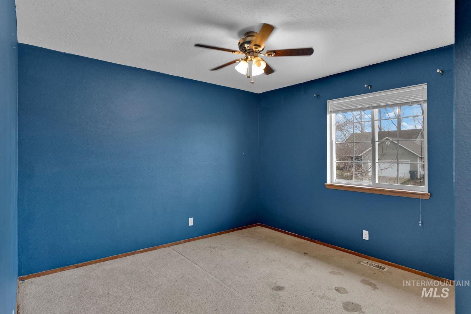 8561 Nebraska Street Rathdrum, ID 83858 - Photo 18 of 50 Carpeted spare room with a ceiling fan and baseboards