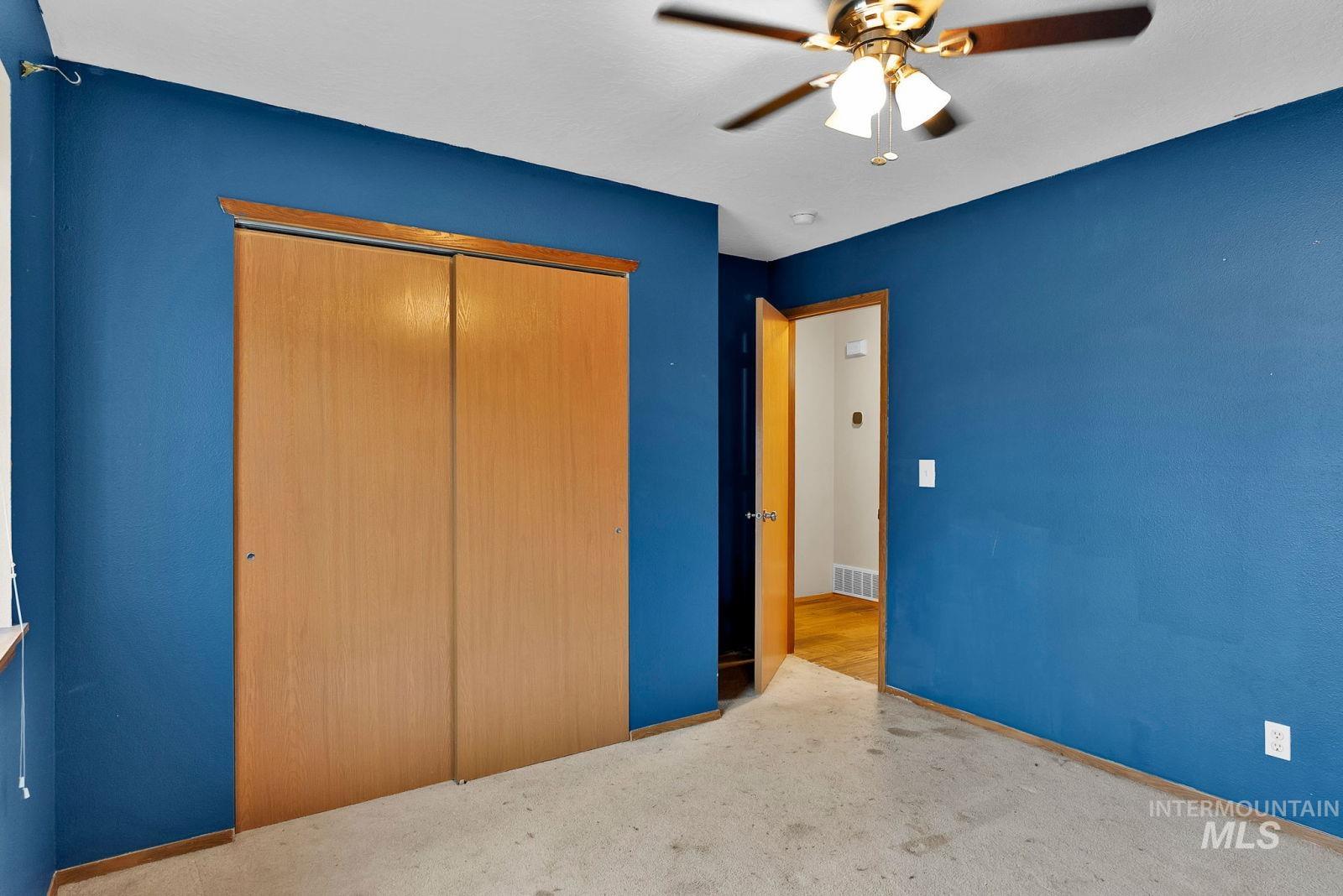 8561 Nebraska Street Rathdrum, ID 83858 - Photo 19 of 50 Unfurnished bedroom featuring light carpet, ceiling fan, and a closet