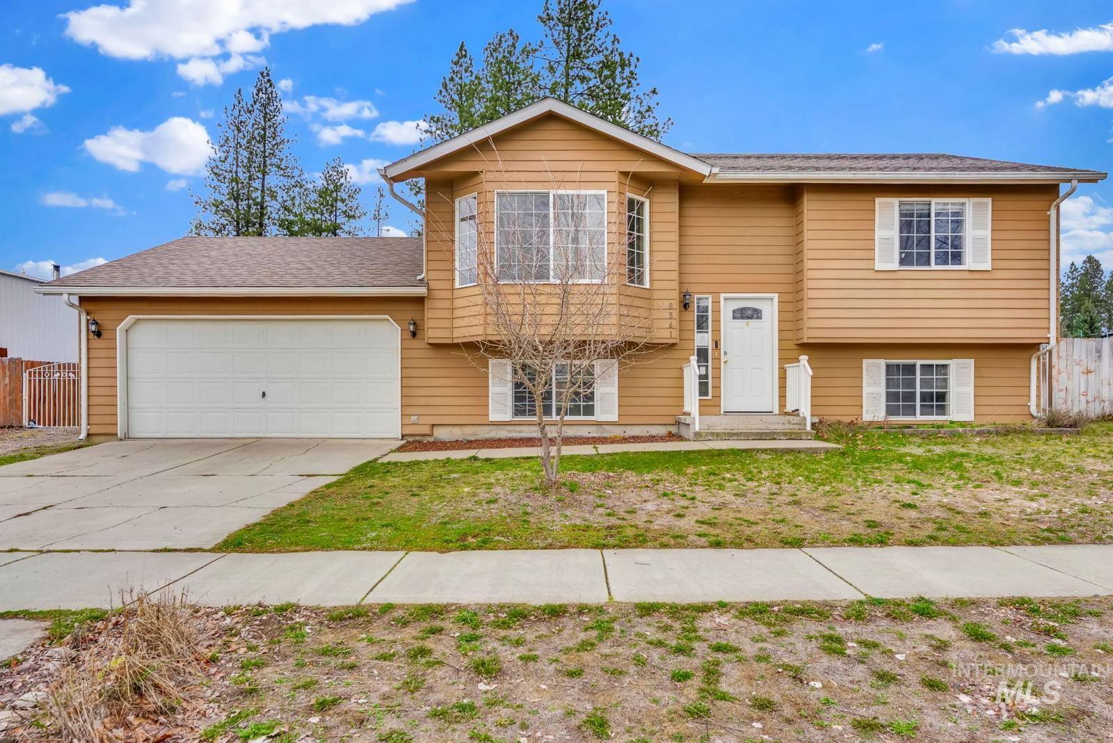 8561 Nebraska Street Rathdrum, ID 83858 - Photo 2 of 50 Raised ranch featuring an attached garage and driveway