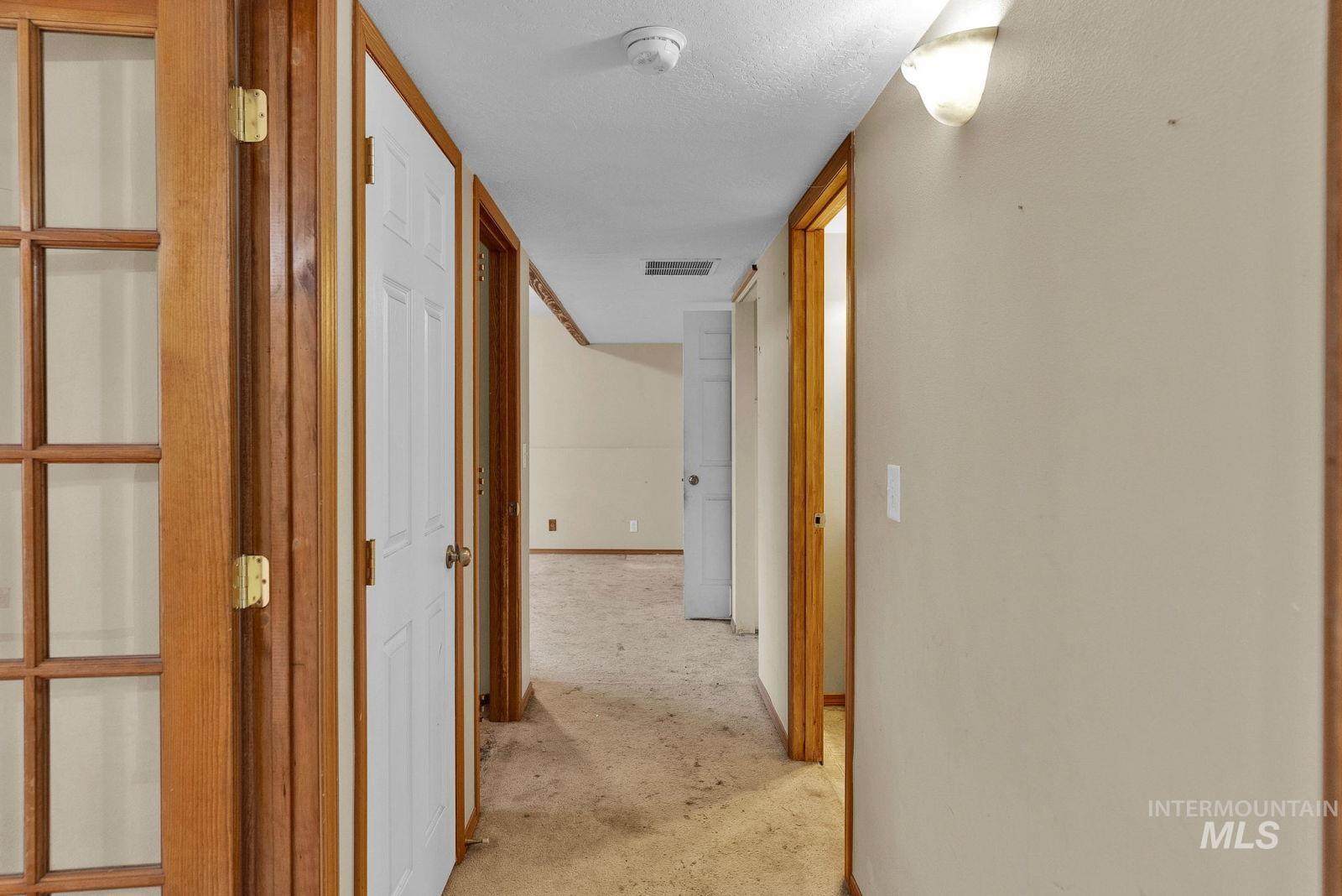 8561 Nebraska Street Rathdrum, ID 83858 - Photo 25 of 50 Corridor with baseboards and a textured ceiling