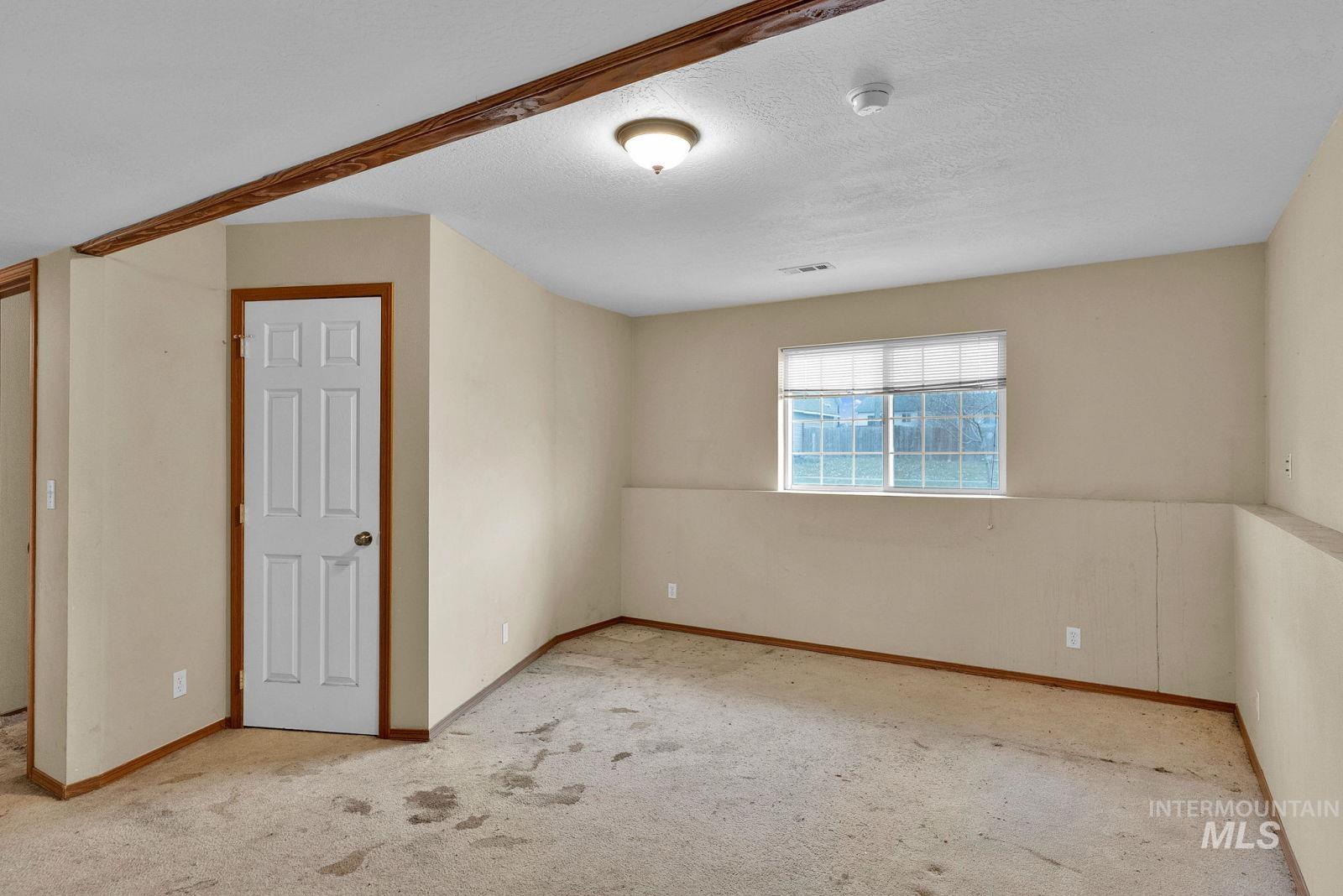 8561 Nebraska Street Rathdrum, ID 83858 - Photo 27 of 50 Carpeted empty room with a textured ceiling and baseboards