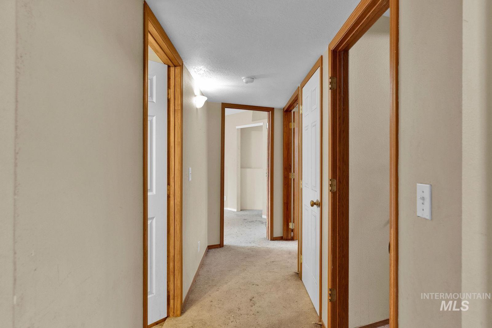8561 Nebraska Street Rathdrum, ID 83858 - Photo 29 of 50 Corridor featuring light colored carpet and a textured ceiling