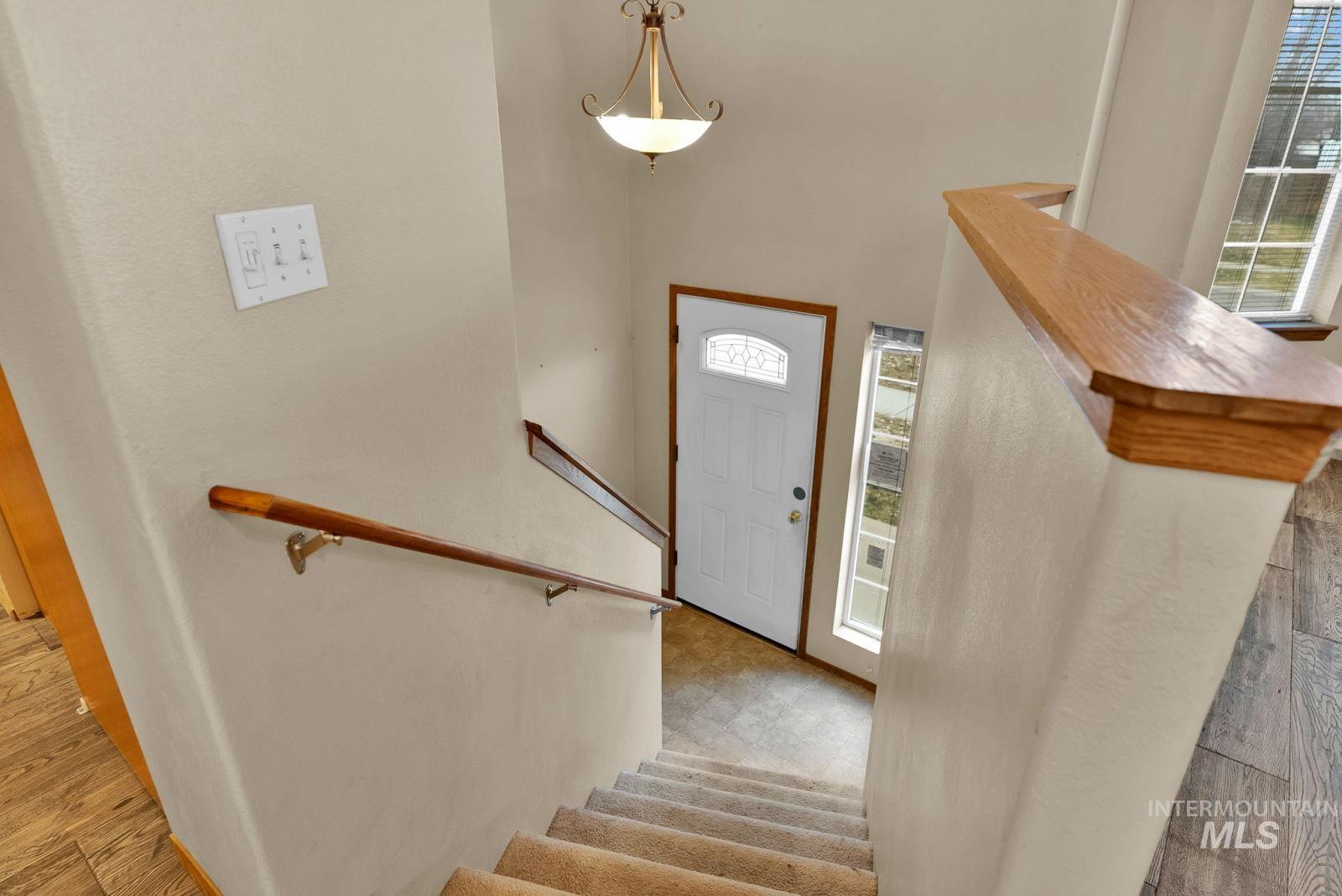 8561 Nebraska Street Rathdrum, ID 83858 - Photo 3 of 50 Foyer entrance featuring stairway and wood finished floors