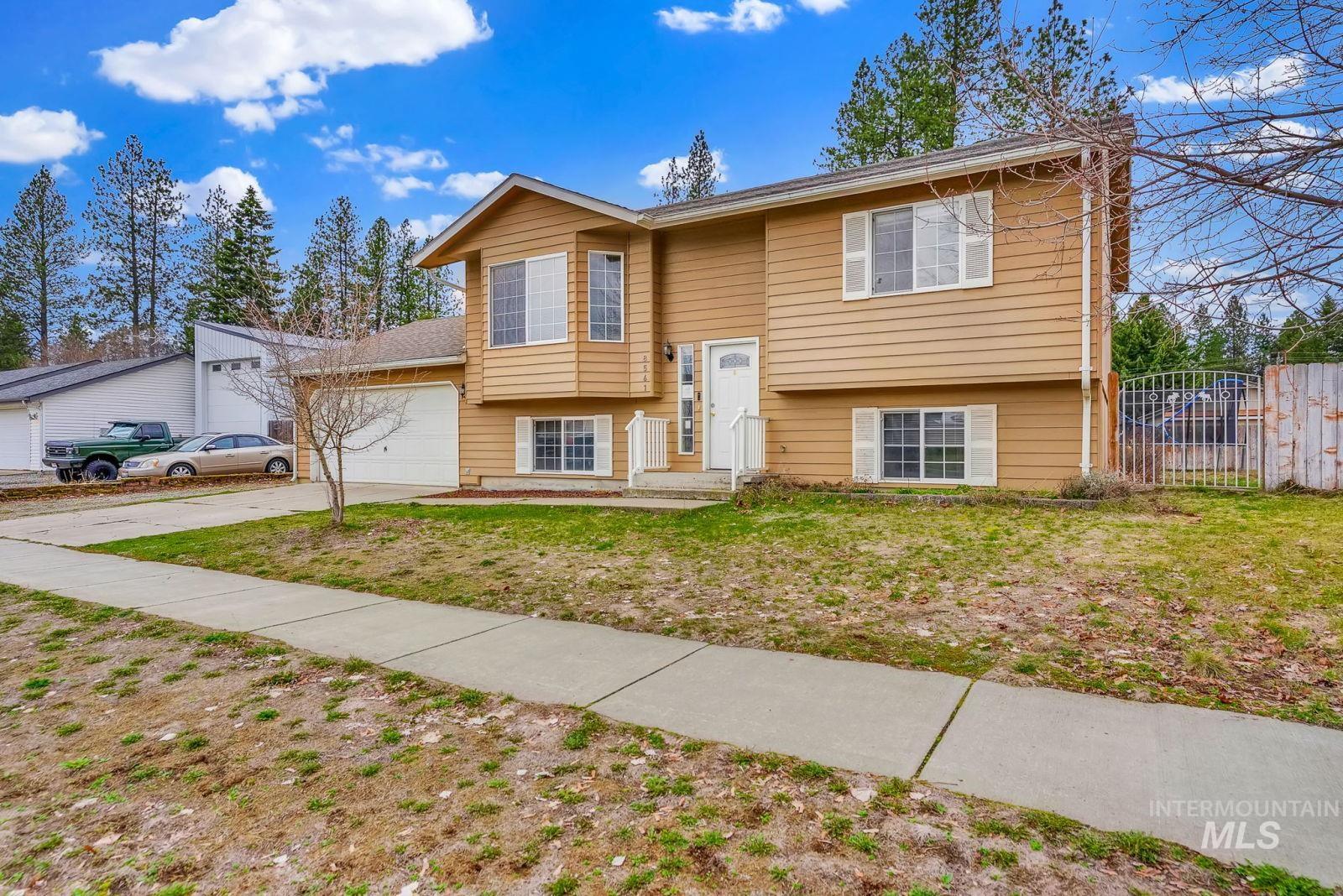 8561 Nebraska Street Rathdrum, ID 83858 - Photo 39 of 50 Raised ranch featuring an attached garage and driveway