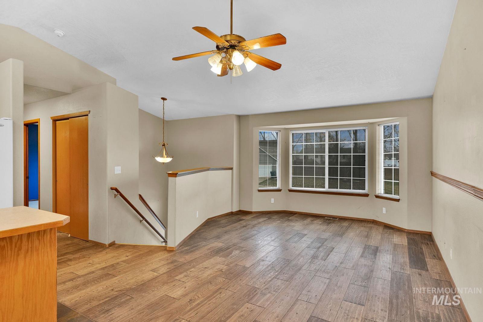 8561 Nebraska Street Rathdrum, ID 83858 - Photo 4 of 50 Empty room with light wood-type flooring and a ceiling fan