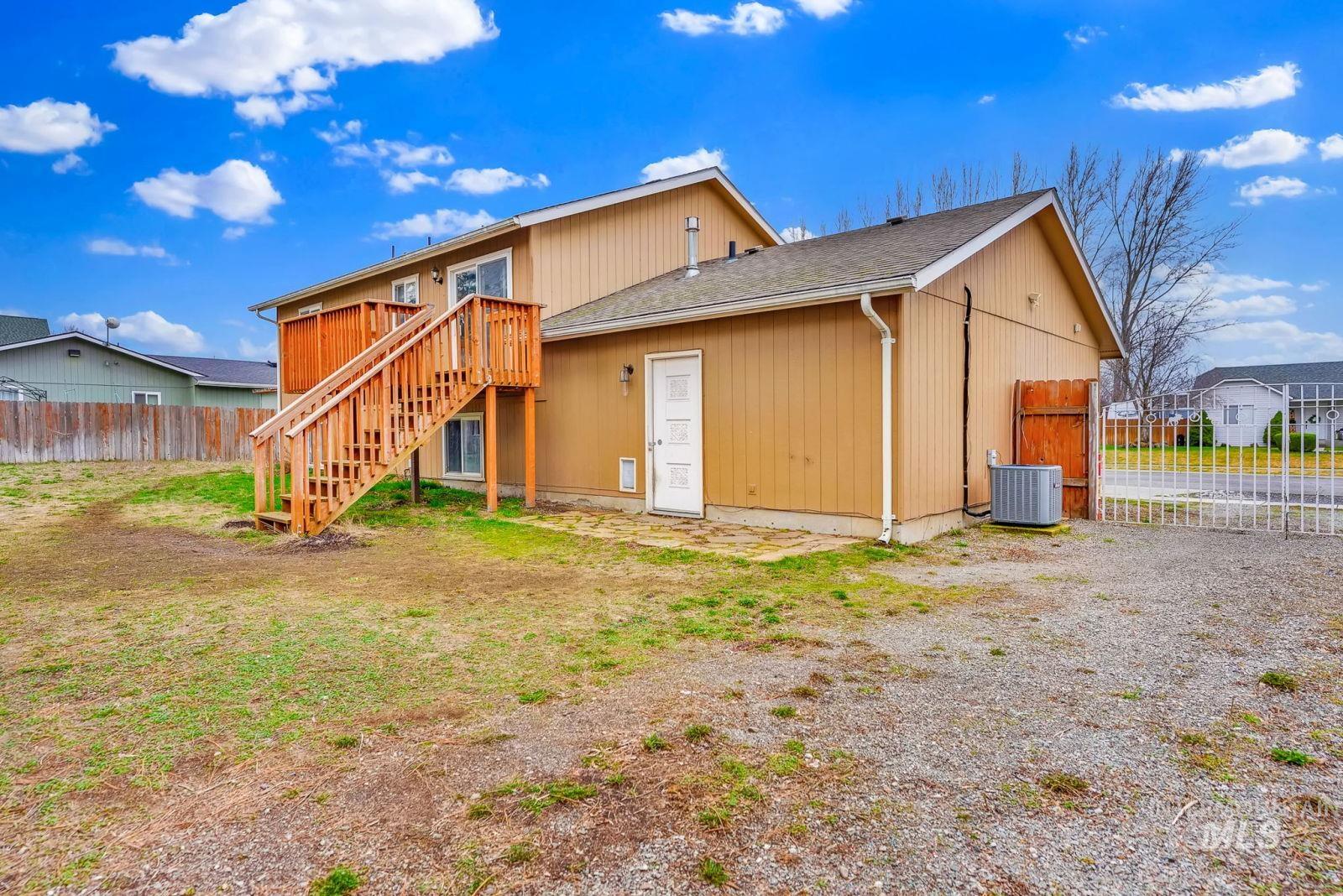 8561 Nebraska Street Rathdrum, ID 83858 - Photo 43 of 50 Back of house featuring stairway and roof with shingles