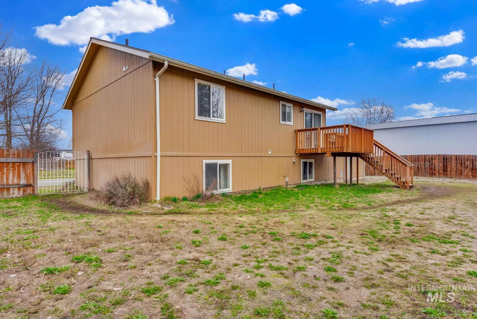 8561 Nebraska Street Rathdrum, ID 83858 - Photo 45 of 50 Back of property featuring a wooden deck and a gate