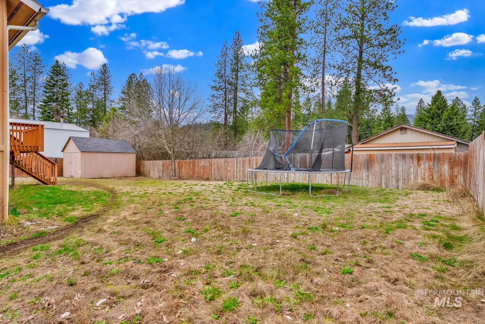 8561 Nebraska Street Rathdrum, ID 83858 - Photo 46 of 50 Fenced backyard with a trampoline and a shed