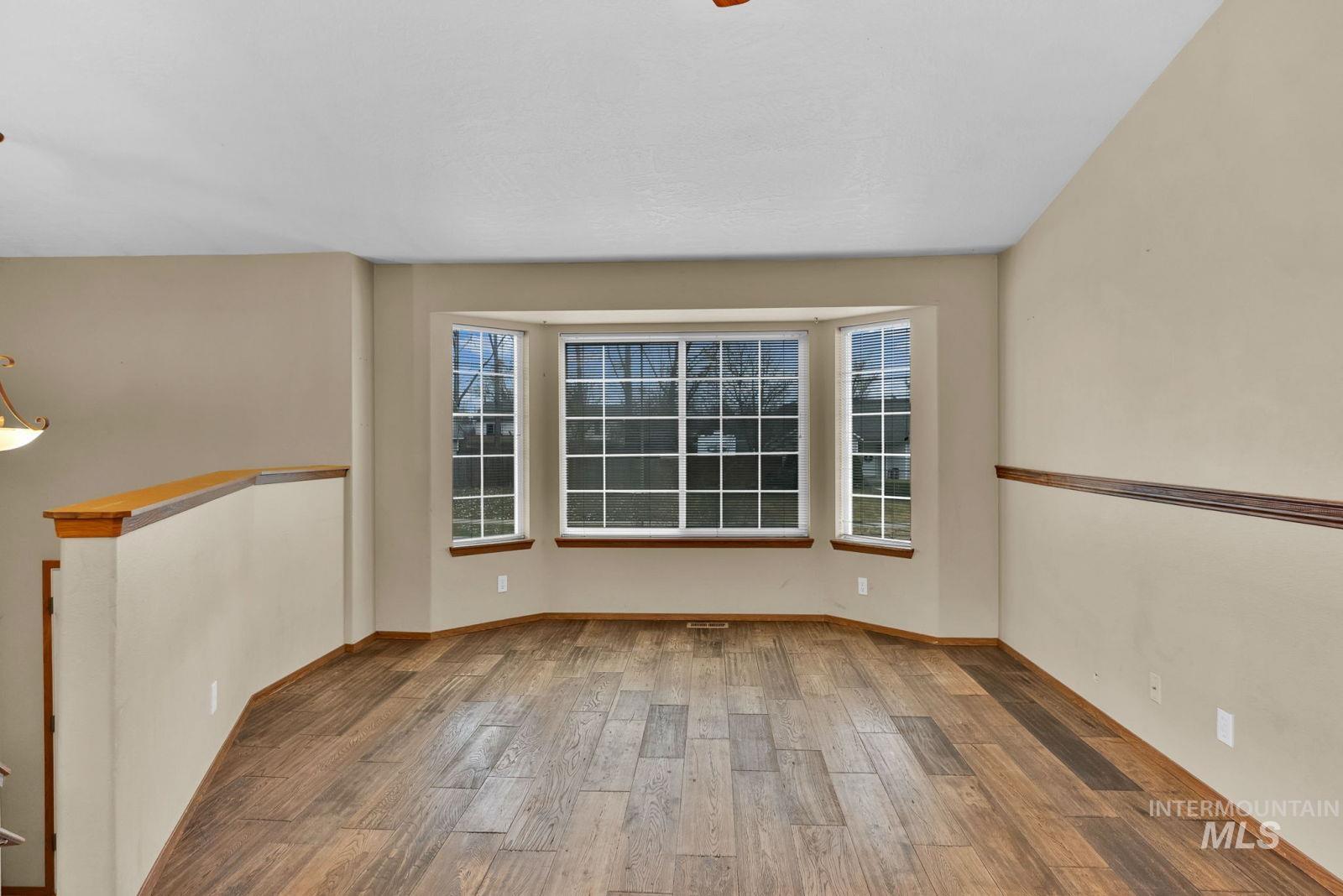 8561 Nebraska Street Rathdrum, ID 83858 - Photo 5 of 50 Empty room with light wood-style flooring and baseboards