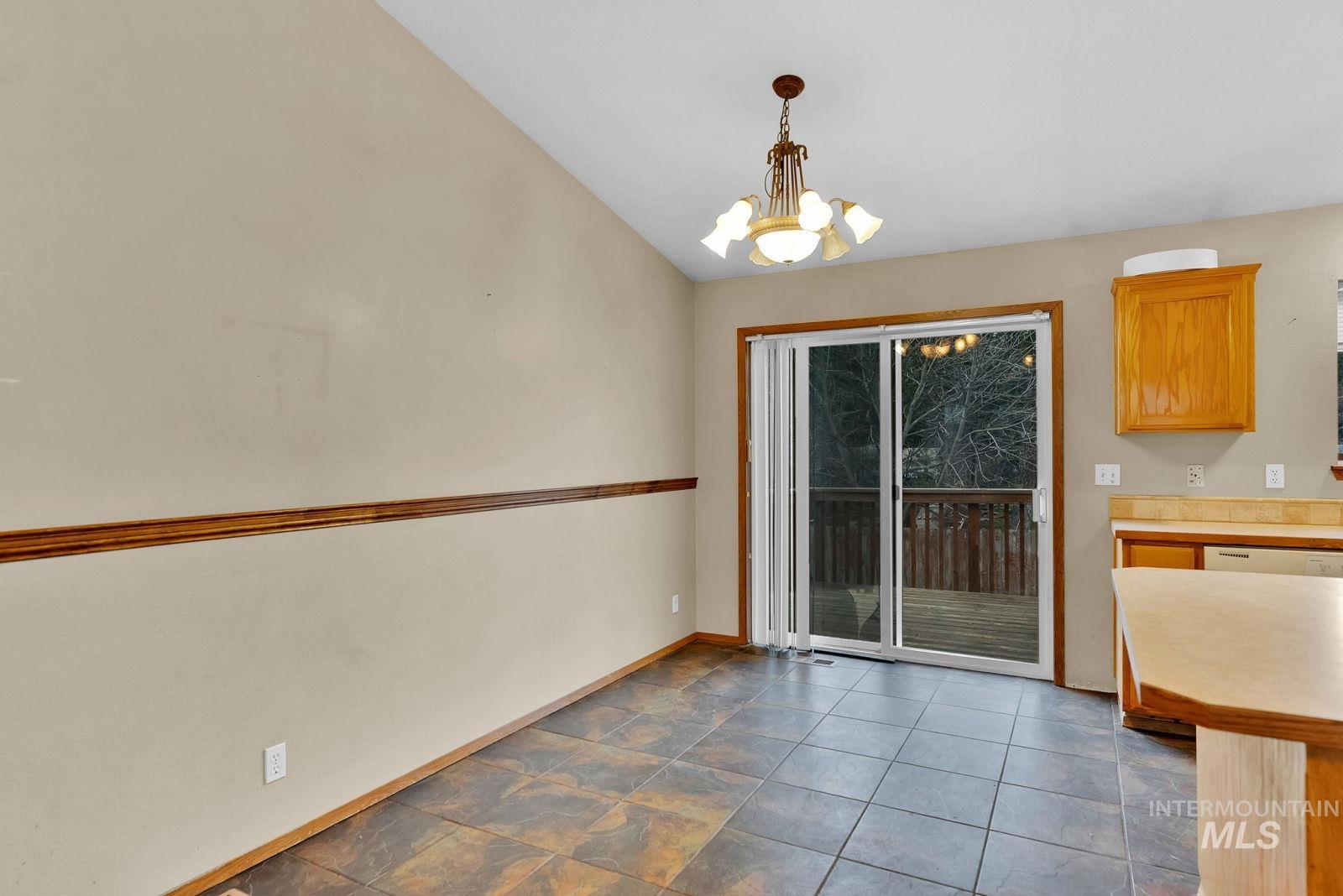 8561 Nebraska Street Rathdrum, ID 83858 - Photo 8 of 50 Unfurnished dining area featuring suspended lighting and vaulted ceiling
