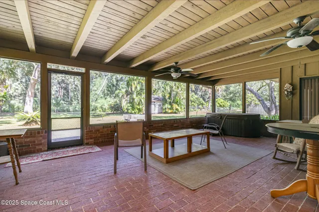 a living room with furniture a wooden floor and next to a window