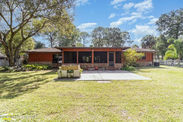 a view of a house with swimming pool and furniture