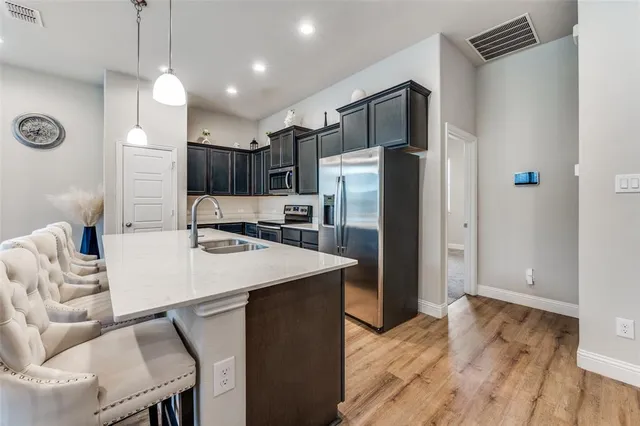 a kitchen with kitchen island a refrigerator stove and microwave