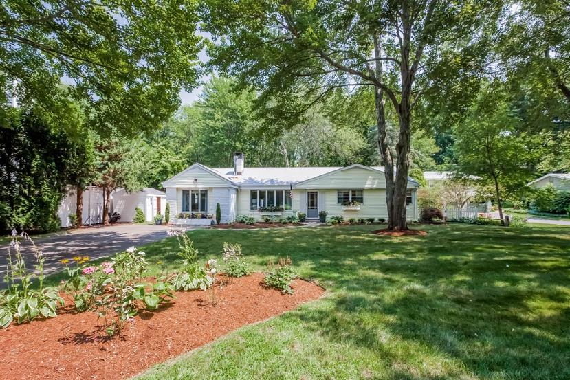 a front view of a house with a garden